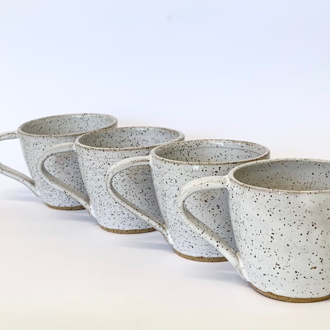 White speckled cups.  Glossy glaze finish. ( Set of four cups)